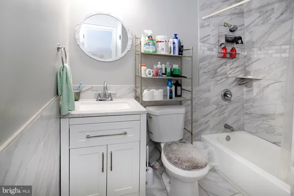 a bathroom with a sink toilet and a mirror