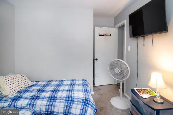 a bedroom with a bed and flat screen tv