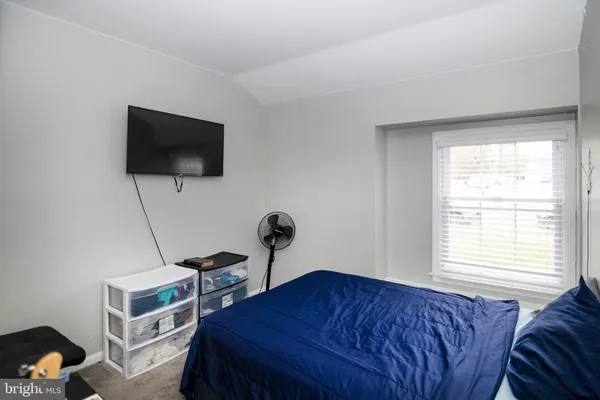 a bedroom with bed and a flat screen tv