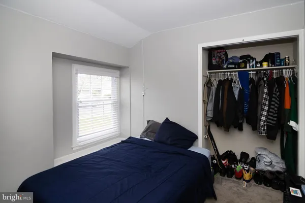 a bed room with a bed and a window