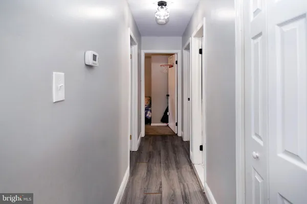 a view of a room with wooden floor