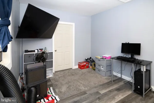 a view of a kitchen with fridge and workspace