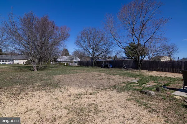 a view of house with backyard space