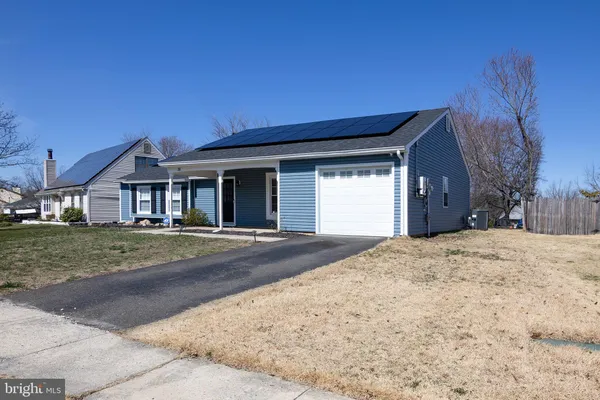 a view of a house with a yard and a garage