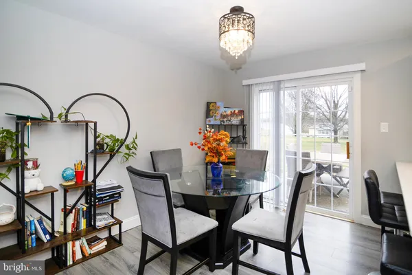 a view of a dining room with furniture and chandelier