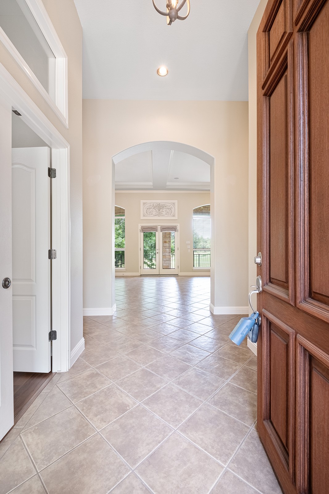 14909 Spillman Ranch Loop Austin, TX 78738 - Photo 17 of 40 Hallway featuring baseboards, arched walkways, recessed lighting, and light tile patterned floors