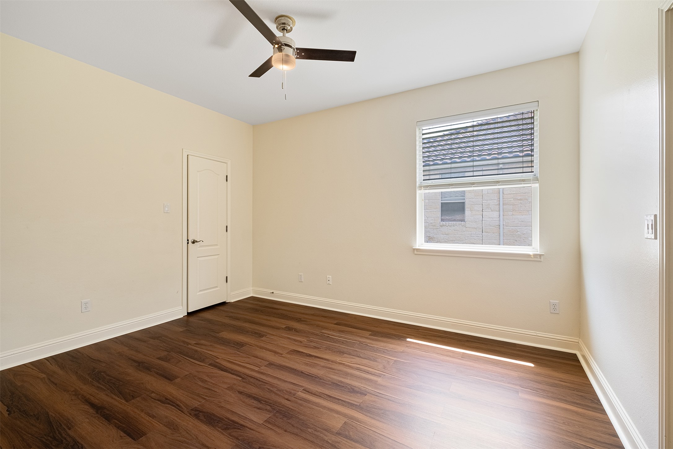 14909 Spillman Ranch Loop Austin, TX 78738 - Photo 21 of 40 Empty room with baseboards, a ceiling fan, and dark wood-type flooring