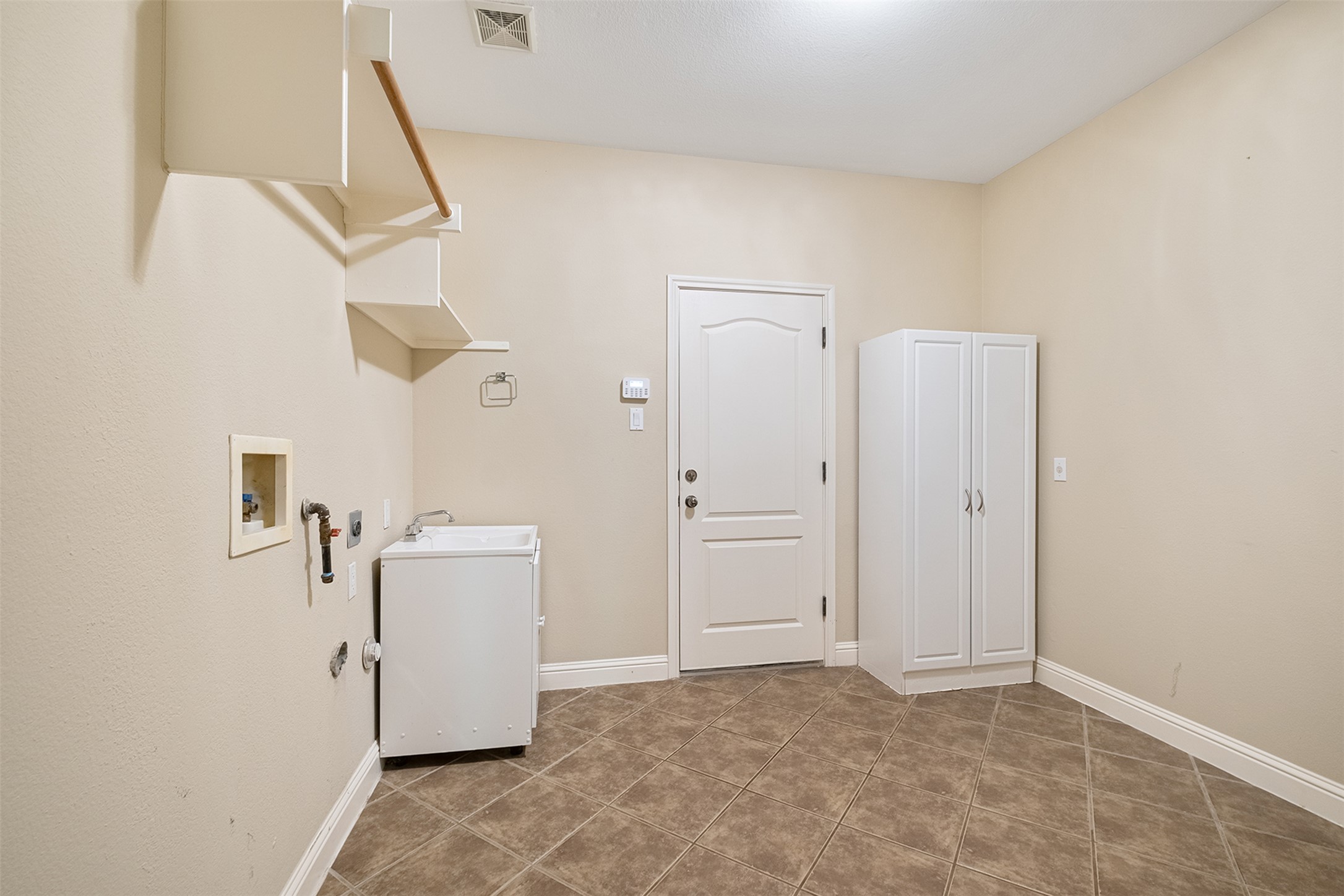 14909 Spillman Ranch Loop Austin, TX 78738 - Photo 23 of 40 Laundry area with baseboards, visible vents, tile patterned flooring, and laundry area