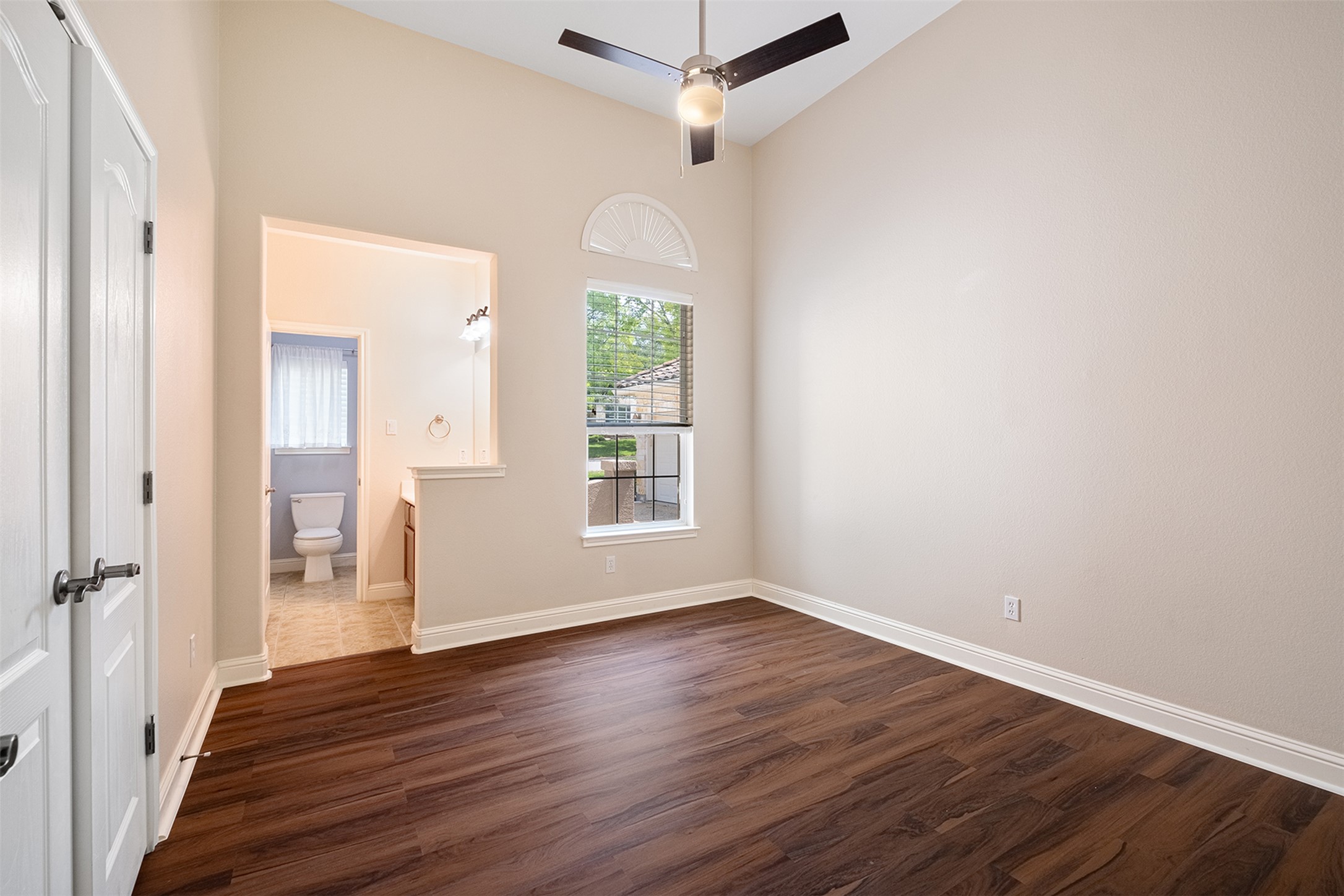 14909 Spillman Ranch Loop Austin, TX 78738 - Photo 24 of 40 Empty room featuring high vaulted ceiling, baseboards, dark wood-style floors, and ceiling fan