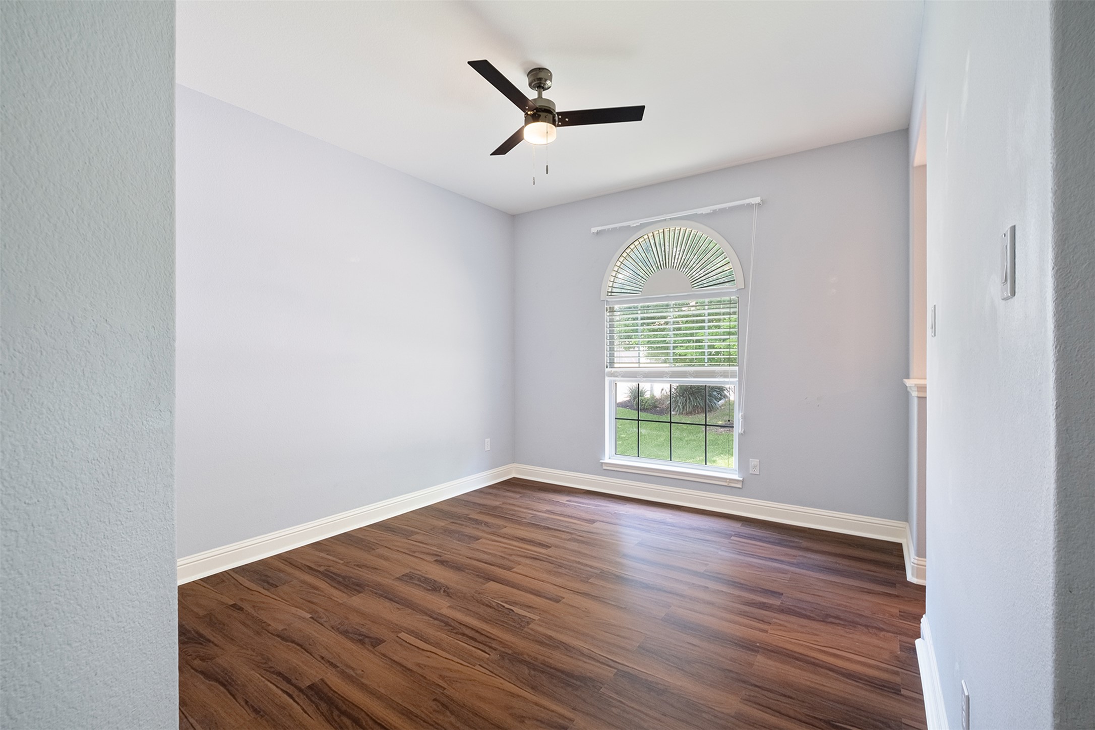 14909 Spillman Ranch Loop Austin, TX 78738 - Photo 28 of 40 Spare room with dark wood finished floors, baseboards, and ceiling fan