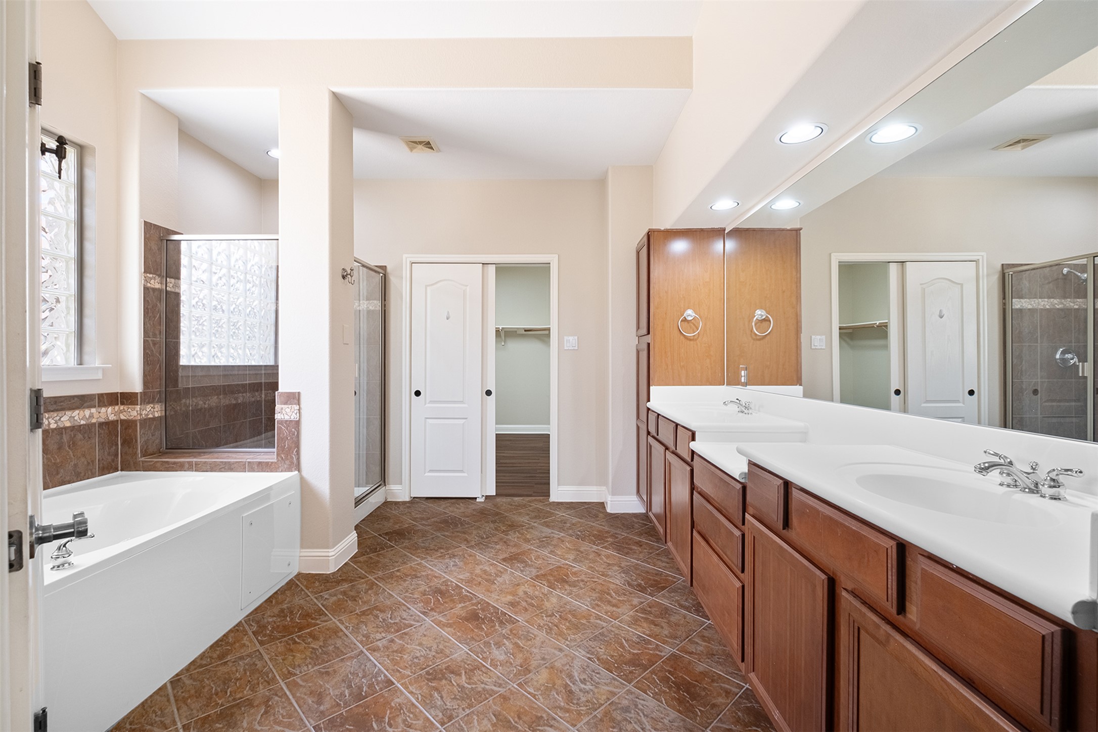 14909 Spillman Ranch Loop Austin, TX 78738 - Photo 32 of 40 Bathroom featuring a sink, baseboards, a spacious closet, visible vents, and a shower stall