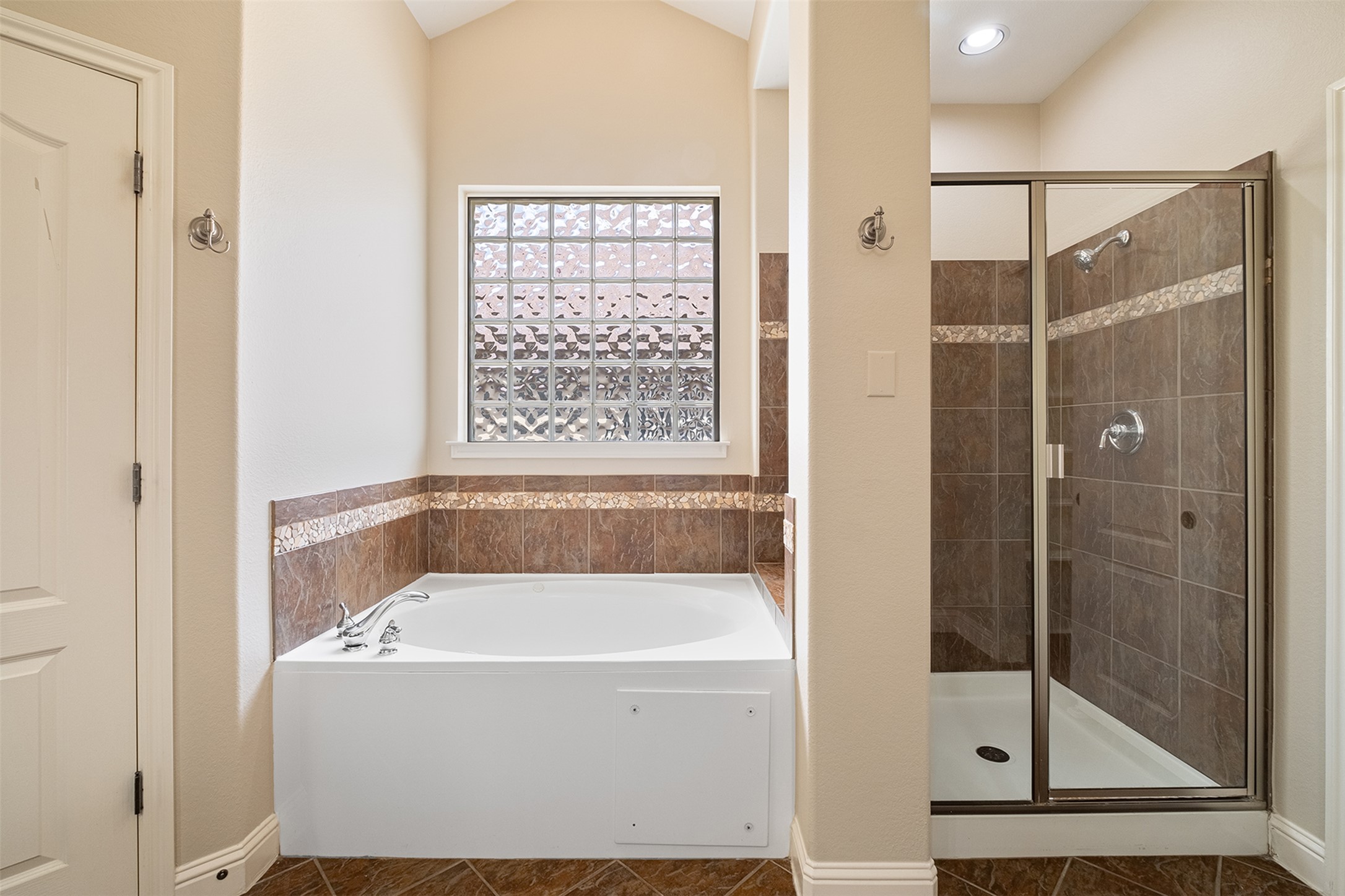 14909 Spillman Ranch Loop Austin, TX 78738 - Photo 34 of 40 Bathroom featuring tile patterned floors, a garden tub, baseboards, and a stall shower