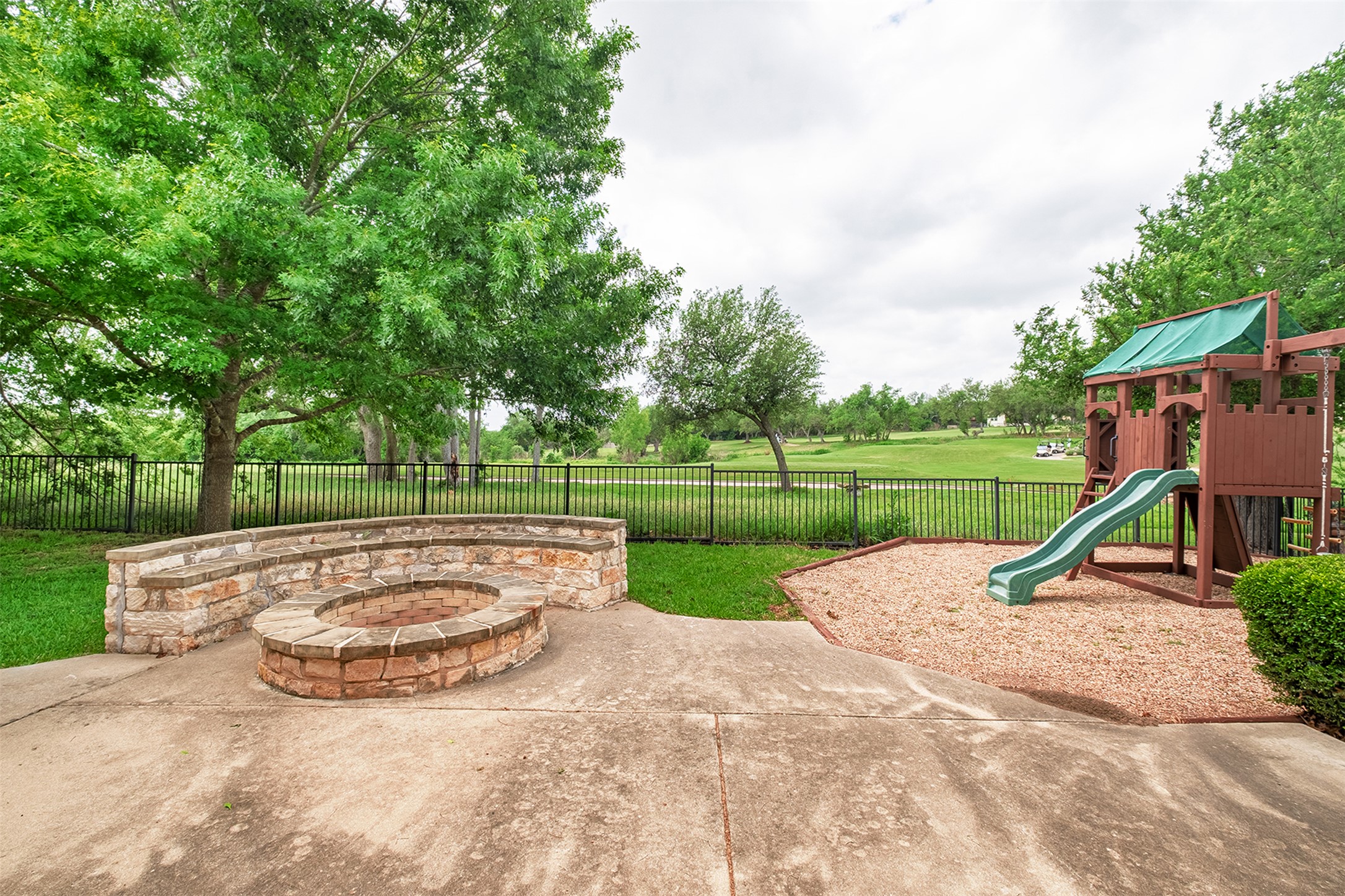 14909 Spillman Ranch Loop Austin, TX 78738 - Photo 39 of 40 View of patio / terrace with a fenced backyard, a playground, and an outdoor fire pit