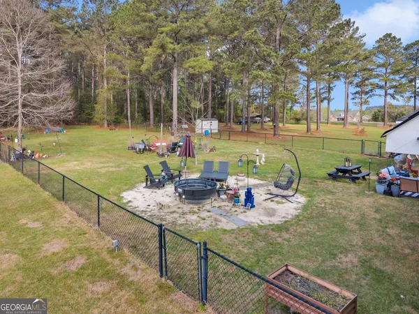 a view of a wooden chairs and fire pit in the patio