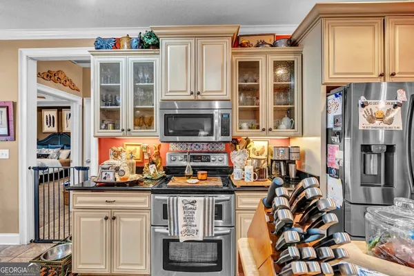a kitchen with stainless steel appliances granite countertop a stove a sink and a refrigerator
