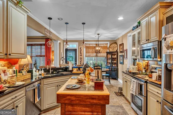 a dining room with furniture a chandelier and wooden floor