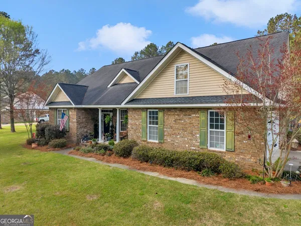 a front view of house with yard and green space