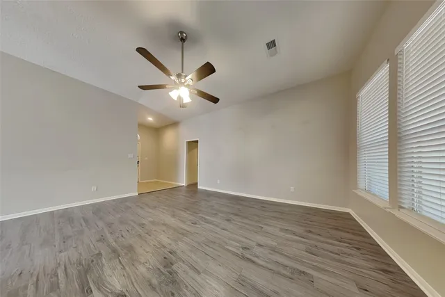 wooden floor in an empty room with a window
