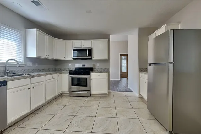 a kitchen with a refrigerator sink and microwave