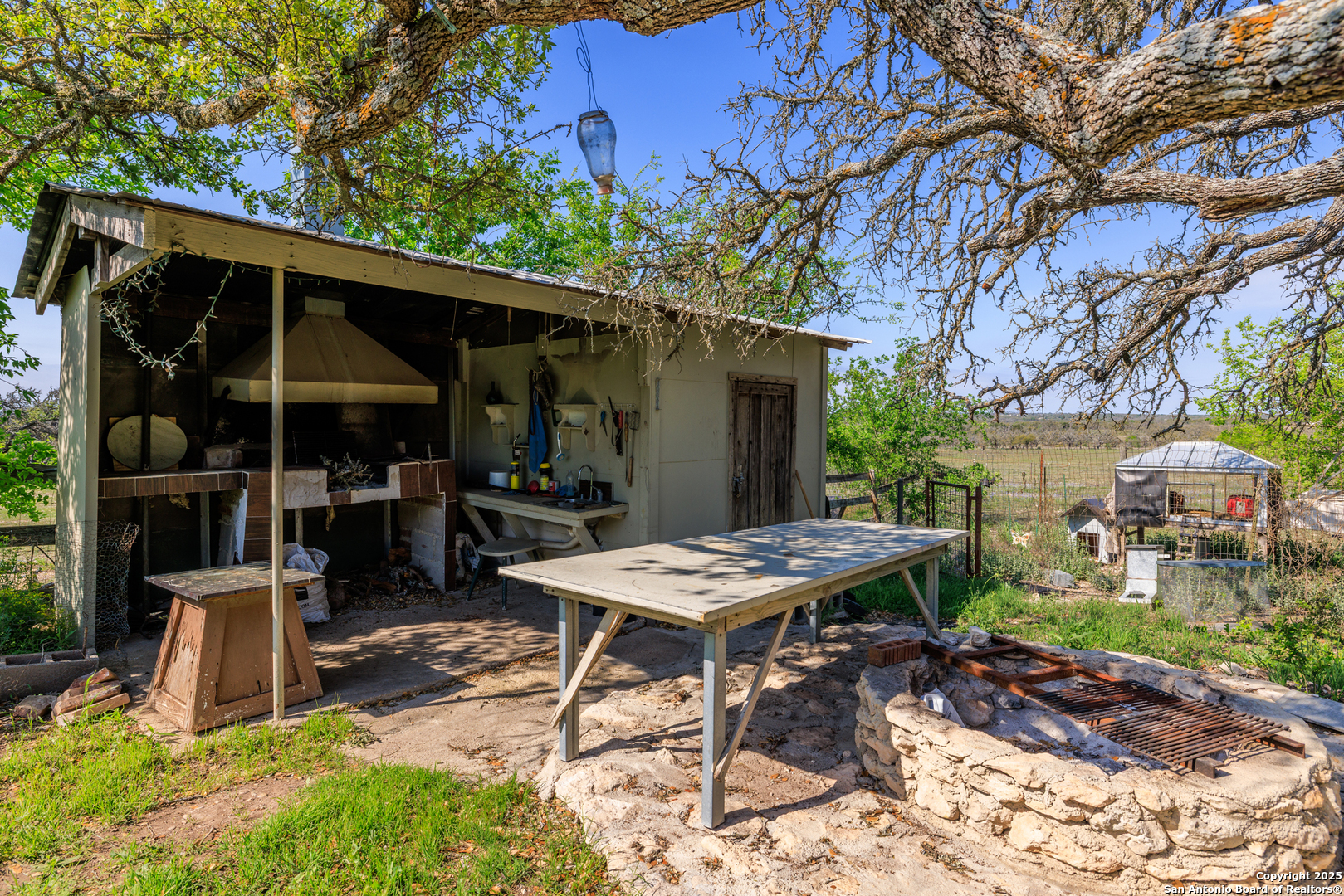 453 Reeves Lane Harper, TX 78631 - Photo 25 of 31 a view of a patio with a table and chairs under an umbrella