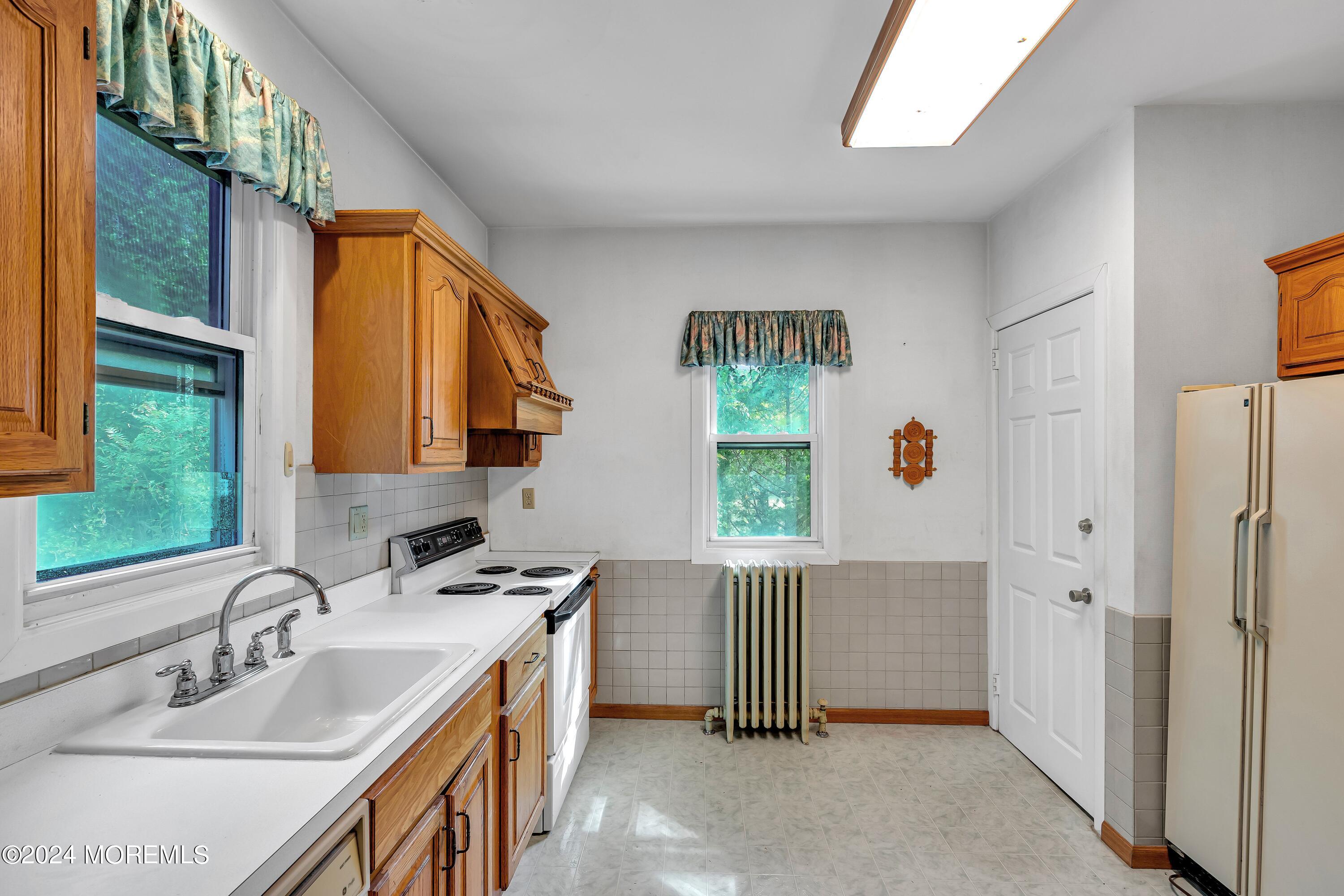 53 Estelle Lane Howell, NJ 07731 - Photo 11 of 36 a bathroom with a sink a window and a mirror