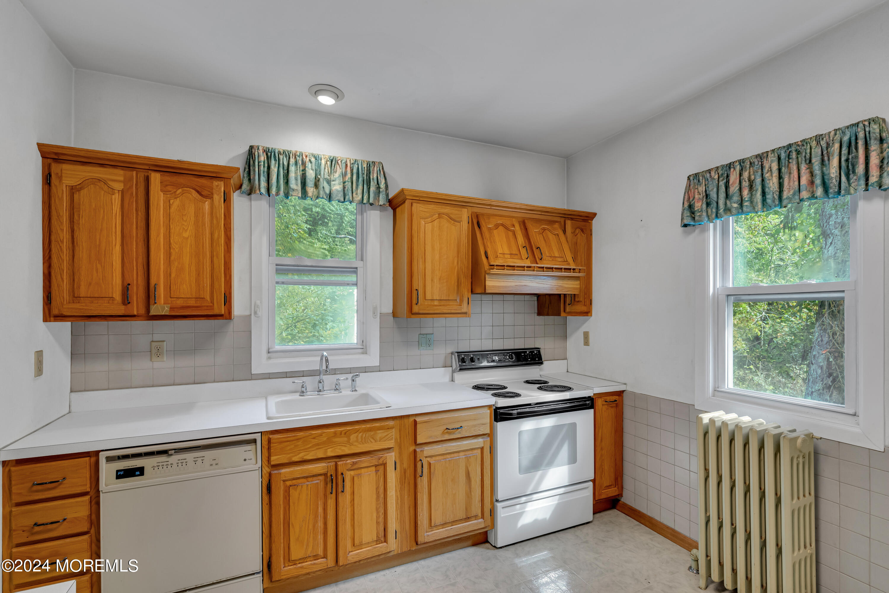 53 Estelle Lane Howell, NJ 07731 - Photo 13 of 36 a kitchen with stainless steel appliances a stove sink and a window