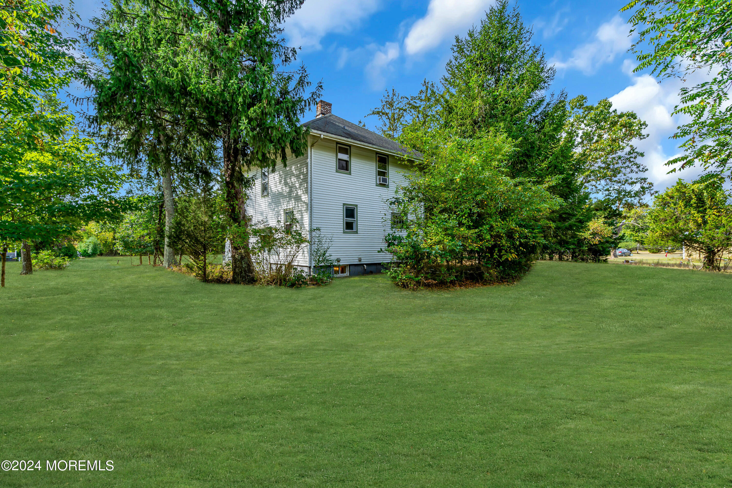 53 Estelle Lane Howell, NJ 07731 - Photo 30 of 36 a backyard of a house with plants and large trees