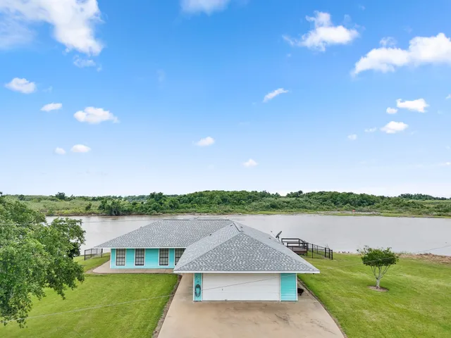 a aerial view of a house with lake view and a big yard