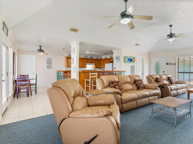 a living room with furniture ceiling fan and a rug