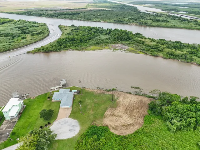 an aerial view of a house with a lake view