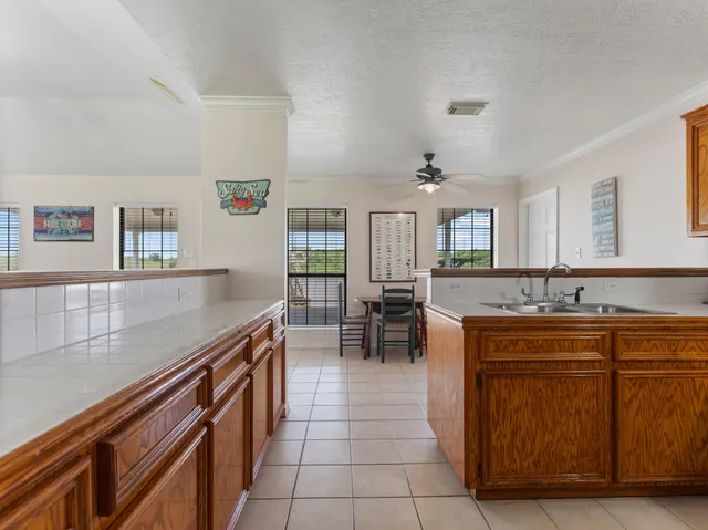 a kitchen with counter top space and windows