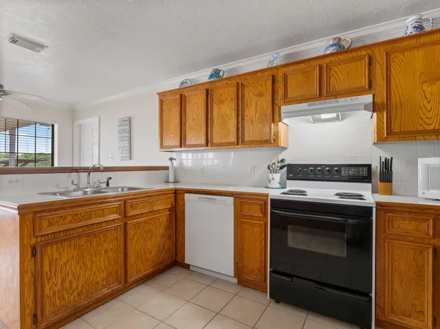 a kitchen with a sink stove and microwave