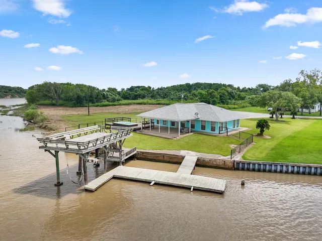 a view of swimming pool with seating area and lake view