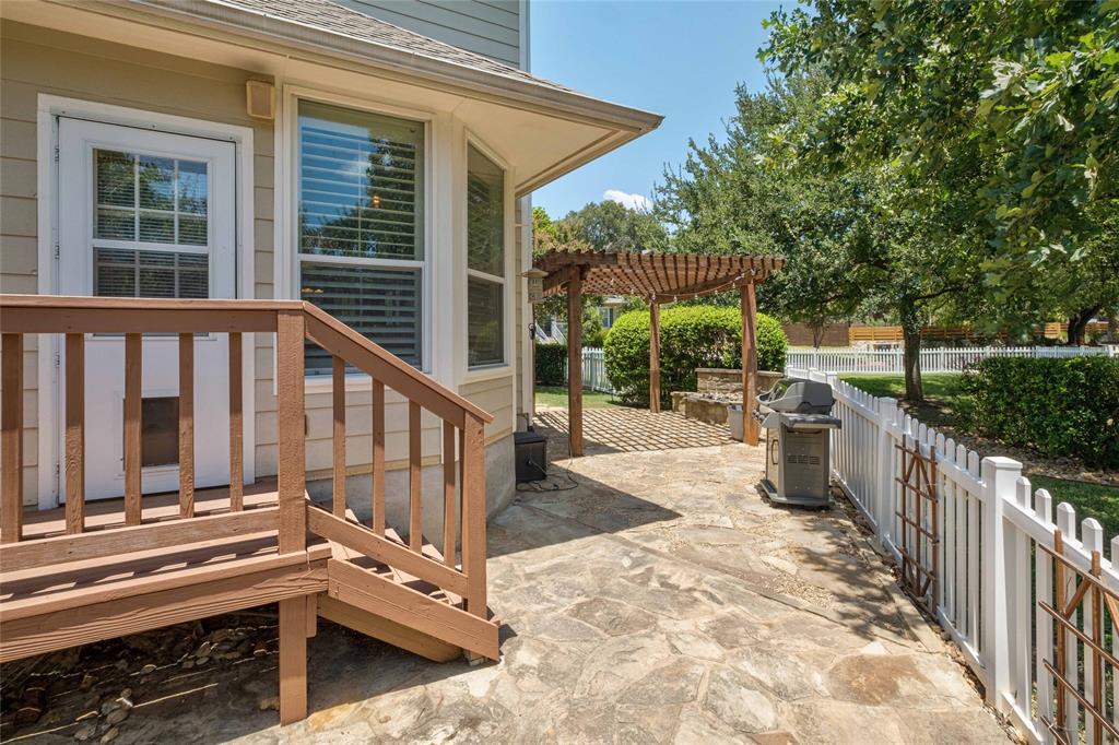 2730 Kinney Oaks Court Austin, TX 78704 - Photo 24 of 32 A spacious stone patio connects a raised wooden deck with a custom wooden pergola.