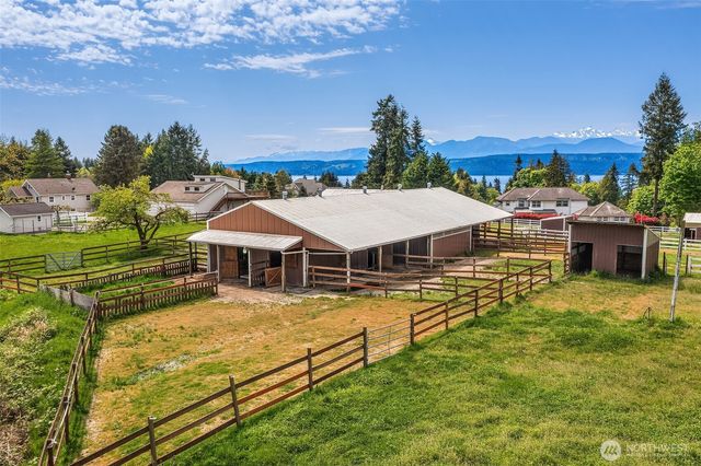 an aerial view of a house with swimming pool garden and patio