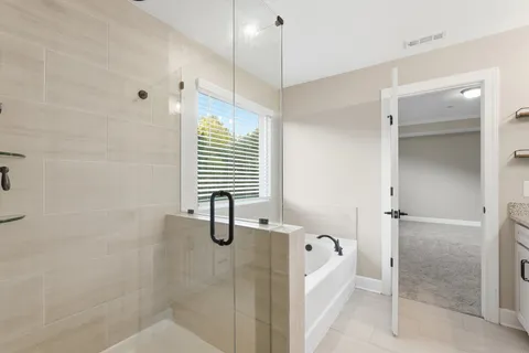 a bathroom with a bathtub and shower