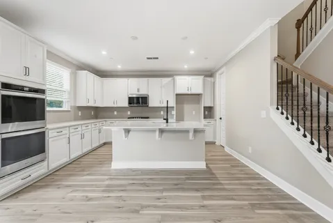 a kitchen with white cabinets and white appliances