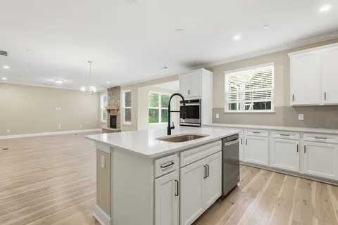 a kitchen with a sink stove and cabinets
