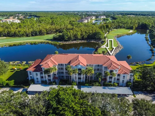 an aerial view of a house with swimming pool garden and lake view