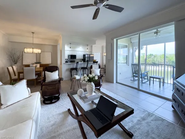 a view of a dining room with furniture a chandelier and wooden floor