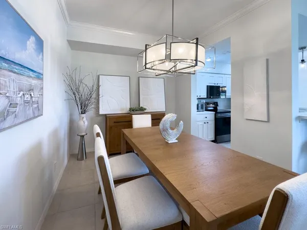 a kitchen with a sink appliances and a dining table