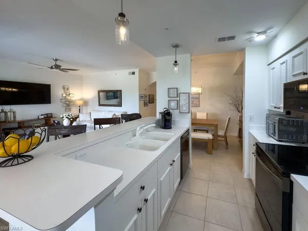 a kitchen with a sink appliances and a counter top space