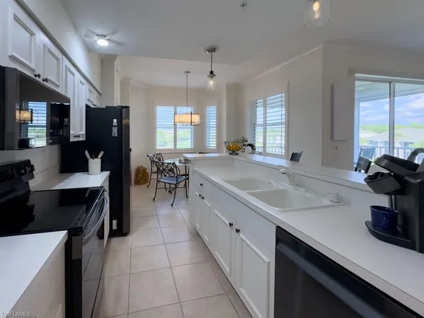a dining room with a table chairs and chandelier