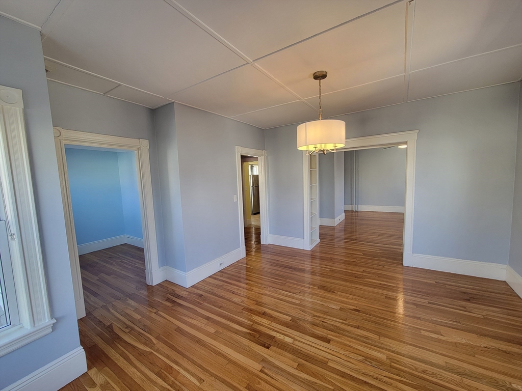 100 Medford Street, Unit 2 Malden, MA 02148 - Photo 11 of 29 a view of a room with wooden floor and chandelier
