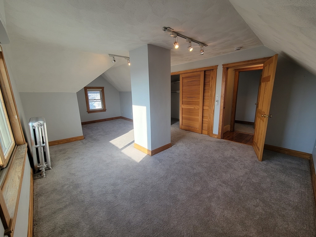 100 Medford Street, Unit 2 Malden, MA 02148 - Photo 22 of 29 an empty room with window and stairs