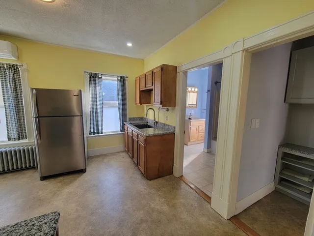 a kitchen with a refrigerator and a stove