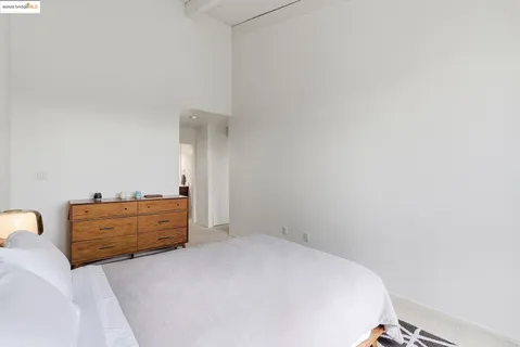 a bedroom with bed and a chair