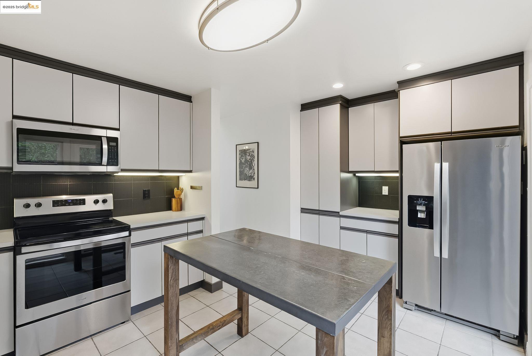 2 Sereno Circle Oakland, CA 94619 - Photo 23 of 42 a kitchen with stainless steel appliances a stove a refrigerator and a microwave