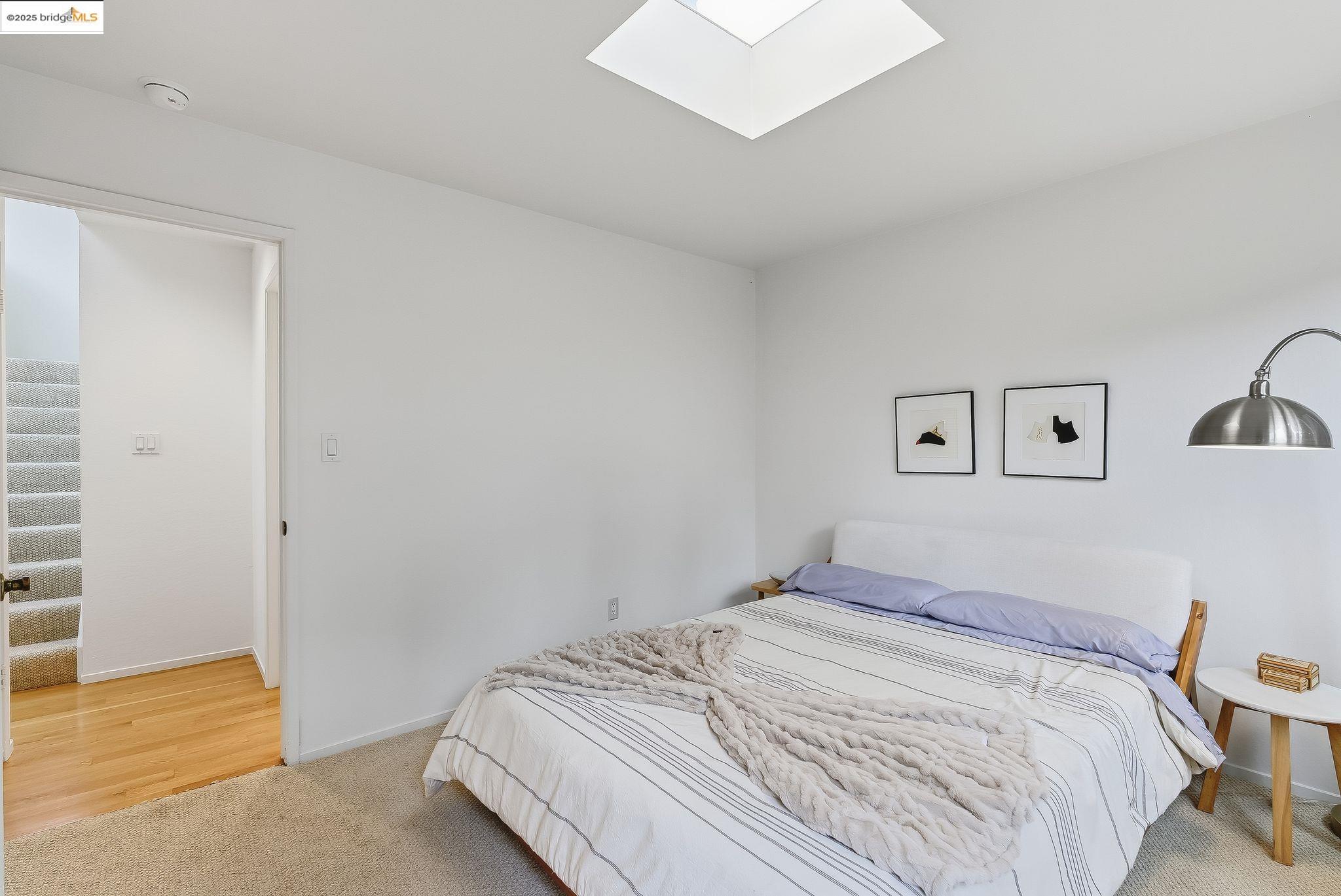 2 Sereno Circle Oakland, CA 94619 - Photo 30 of 42 a bedroom with a bed and wooden floor