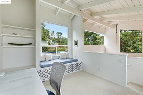 a room with gym equipment and a view of living room